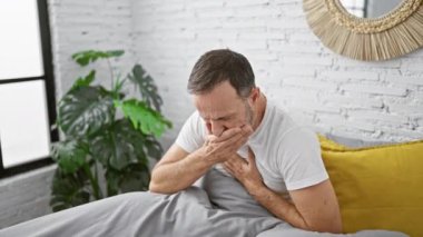 Hasta, orta yaşlı, gri saçlı, yatakta oturan, yatak odasının yalnızlığında ciğerlerini öksüren, sabahın erken saatlerinde griple savaşan bir adam.