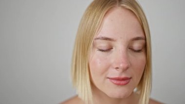 Young blonde woman smiling confident standing over isolated white background