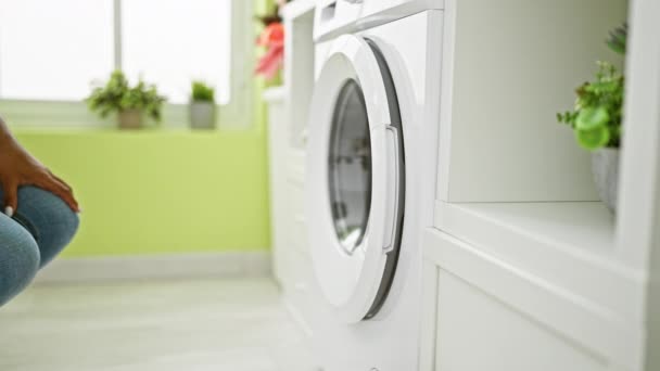 非洲裔美国妇女试图在洗衣房打开洗衣机 — 图库视频影像