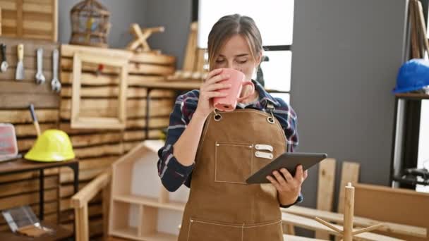 Attractive Young Blonde Carpenter Woman Coffee Hand Navigating Touchpad Amidst — Stock Video