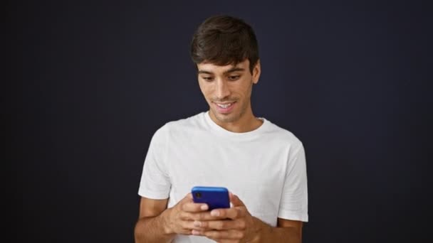 Cheerful Young Hispanic Man Celebrates His Win Joyfully Texting His — Stock Video