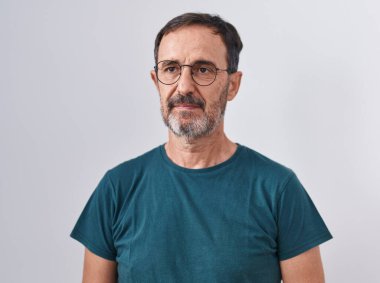 Middle age man standing with serious expression over isolated white background