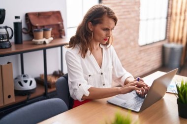 Young beautiful hispanic woman business worker using laptop working at office