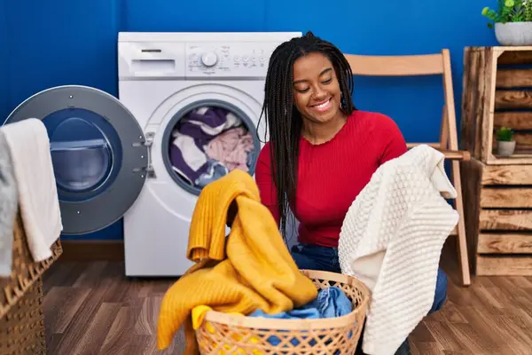 African American Woman Smiling Confident Washing Clothes Laundry Room — стоковое фото