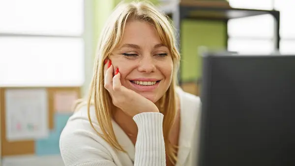 Young blonde woman business worker using computer working at office
