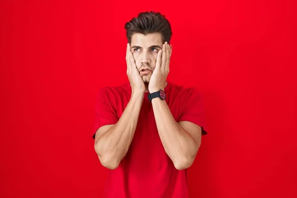 Young Hispanic Man Standing Red Background Tired Hands Covering Face — Stock fotografie