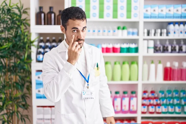 Handsome Hispanic Man Working Pharmacy Drugstore Pointing Eye Watching You — Stock Photo, Image