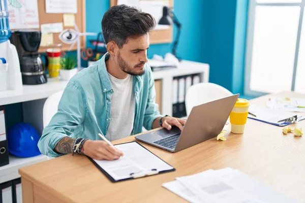 Young Hispanic Man Business Worker Using Laptop Writing Document Office — Zdjęcie stockowe