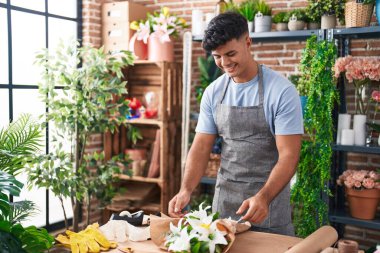 Çiçekçide çiçek buketi yapan genç bir İspanyol.