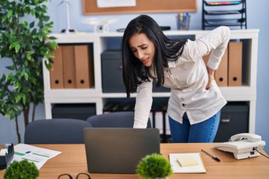 Young caucasian woman business worker suffering for backache at office