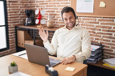 Young man call center agent having video call at office