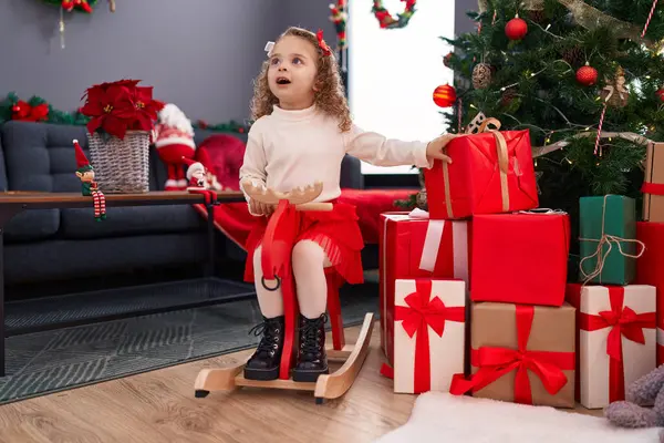 Adorable Blonde Girl Playing Reindeer Rocking Christmas Tree Home — Stock Photo, Image