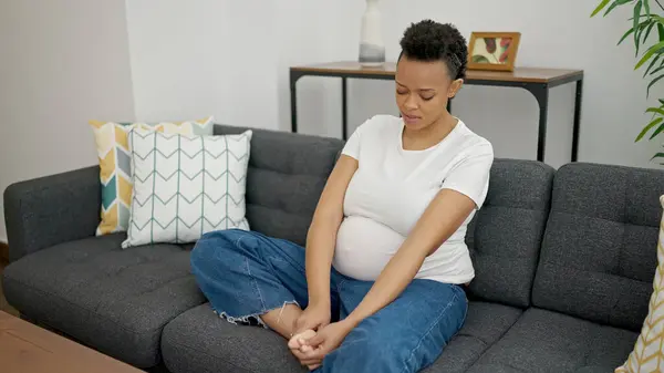 Mladá Těhotná Žena Masíruje Nohy Sedí Pohovce Doma — Stock fotografie