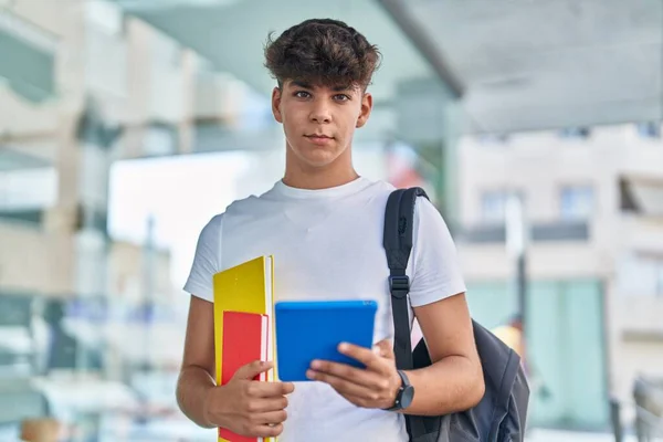 若いですヒスパニック10代の学生使用してタッチパッド保持本で大学 — ストック写真