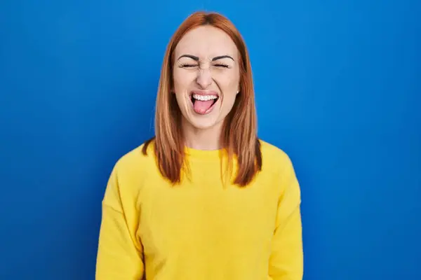 Young Woman Standing Blue Background Sticking Tongue Out Happy Funny — 图库照片