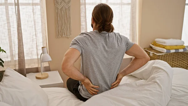 Young Hispanic Man Suffering Backache Sitting Bed Bedroom — Stok fotoğraf