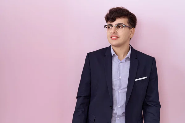 stock image Young non binary man with beard wearing suit and tie looking away to side with smile on face, natural expression. laughing confident. 