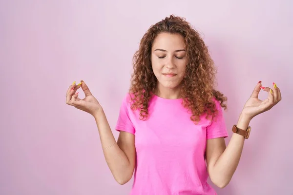 站在粉色背景上的年轻的高加索女人放松了 闭上眼睛 用手指做冥想动作 瑜伽概念 — 图库照片