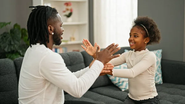 African American Father Daughter Sitting Sofa Playing Hands Game Home — Stock Photo, Image