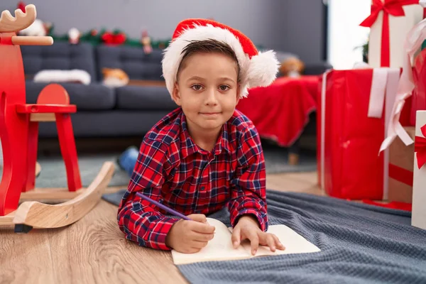 Adorable Hispanic Boy Writing Santa Claus Letter Sitting Christmas Tree — Stok fotoğraf