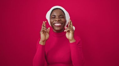 Afrika kökenli Amerikalı bir kadın Noel şapkası takıp şans dilemek için dua ediyor.