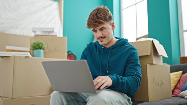 Young Hispanic Man Using Laptop Sitting Sofa New Home — Stok video