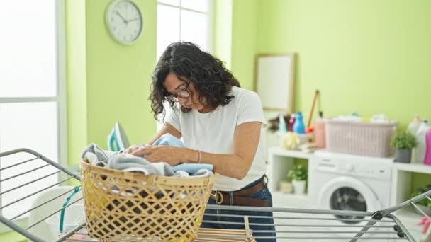 Middle Age Hispanic Woman Leaning Basket Clothes Stressed Laundry Room — Stock Video