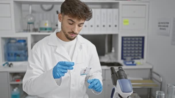 Focused Arabian Scientist Young Man Meticulously Analyzes Sample His Microscope Royalty Free Stock Video