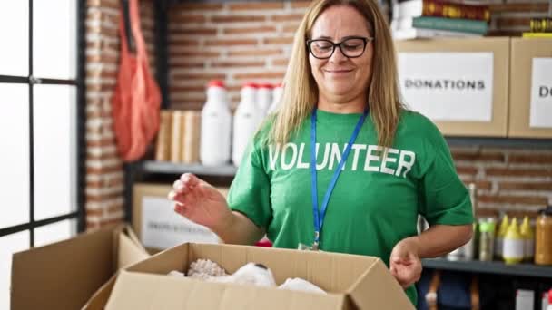 Hiszpanka Średnim Wieku Wolontariuszka Uśmiechnięta Pewna Siebie Pakująca Ubrania Kartonowym — Wideo stockowe