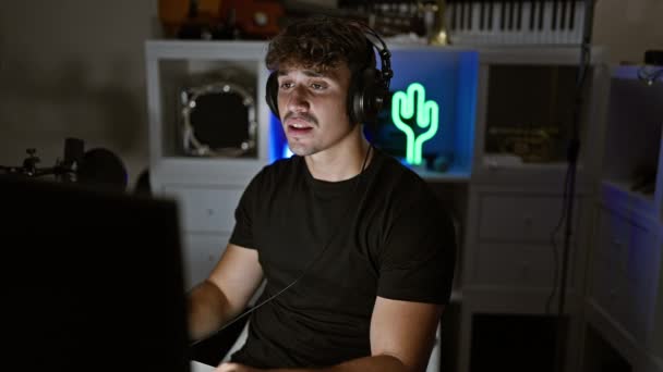 Young Hispanic Man Streamer Having Video Call Taking Notes Gaming — Stock Video