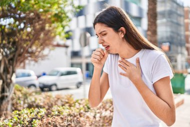 Parkta öksüren genç, güzel İspanyol kadın.
