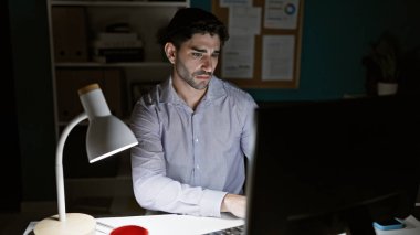 Ofiste çalışan İspanyol bir iş adamı bilgisayar kullanıyor.