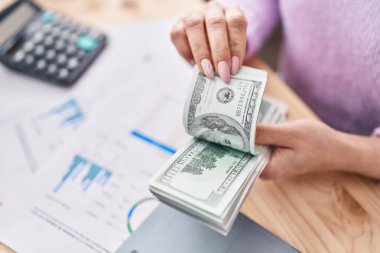 Young caucasian woman ecommerce business worker holding dollars accounting at office
