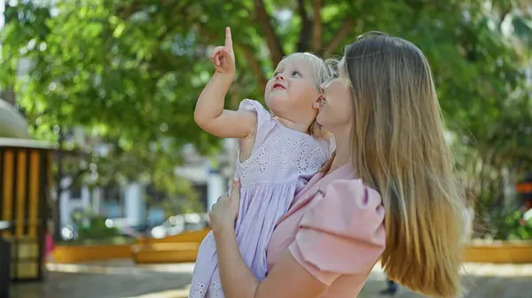Confident Mother Holding Her Cheerful Daughter Arms Standing Park Looking — Stock Photo, Image