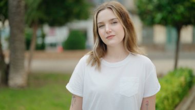 Young caucasian woman smiling confident standing at park