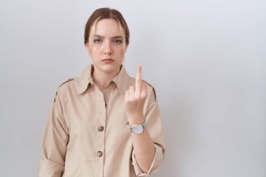 Young caucasian woman wearing casual shirt showing middle finger, impolite and rude fuck off expression 