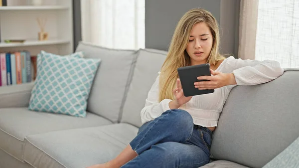 Young Blonde Woman Using Touchpad Sitting Sofa Home — Stockfoto