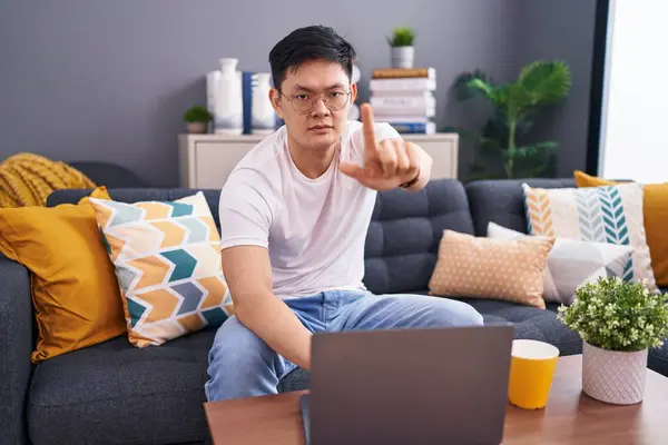 Young Asian Man Using Laptop Home Sitting Sofa Pointing Finger — Stock Photo, Image