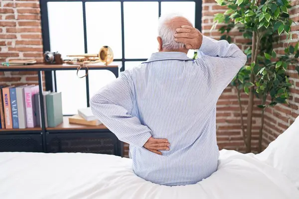 Middle Age Grey Haired Man Suffering Back Injury Sitting Bed — Stok fotoğraf