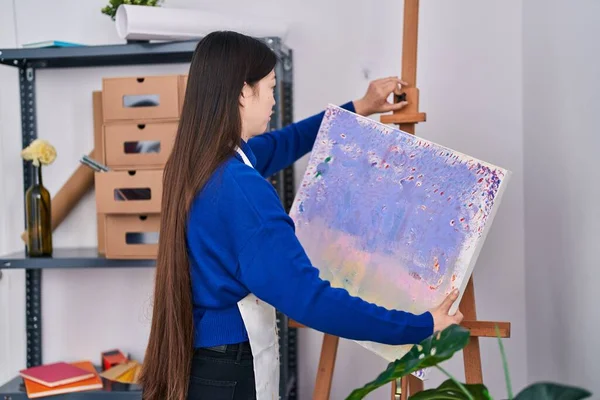 Chinese woman artist holding draw at art studio