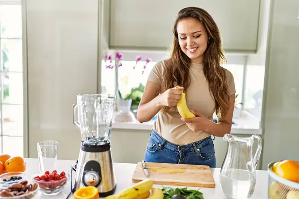年轻美丽的惊慌失措的女人在厨房用搅拌机搅拌蔬菜 剥下香蕉 — 图库照片