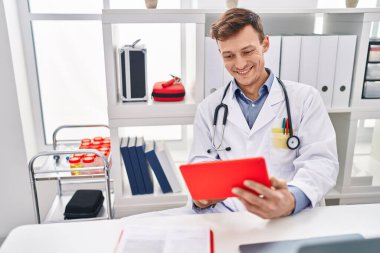 Young man ecommerce business worker suffering for wrist pain at clinic