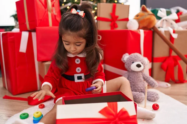 Αξιολάτρευτο Ισπανόφωνο Κορίτσι Που Κάθεται Στο Πάτωμα Χριστουγεννιάτικα Δώρα Παίζοντας — Φωτογραφία Αρχείου