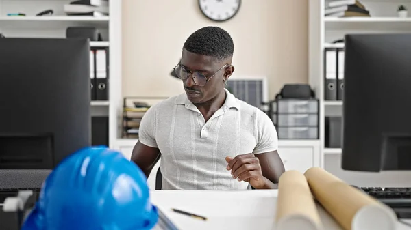 African american man architect sitting on table working at the office