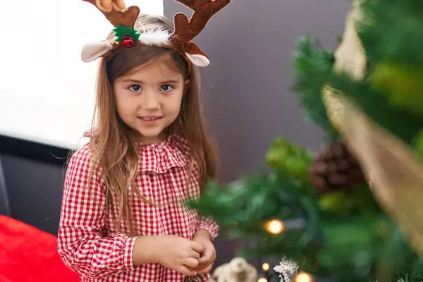 Adorable Blonde Girl Wearing Reindeer Ears Decorating Christmas Tree Home — Stock Photo, Image