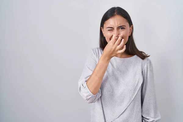 Young Hispanic Woman Standing White Background Smelling Something Stinky Disgusting — ストック写真
