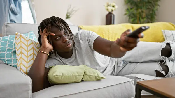African American Man Watching Lying Sofa Boring Expression Home — Stock Photo, Image