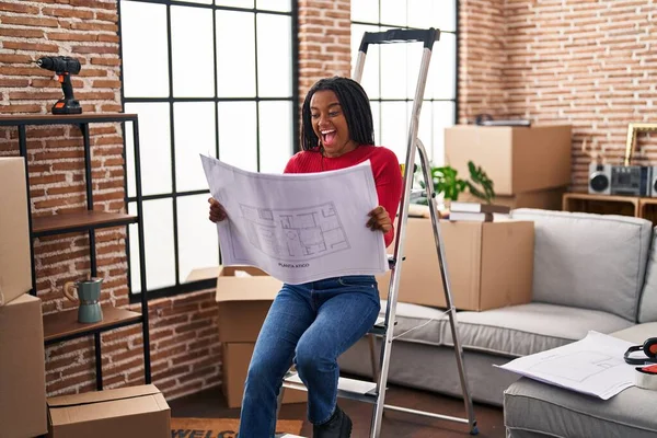 Young African American Braids Standing New Home Looking Blueprints Celebrating — Stock Photo, Image