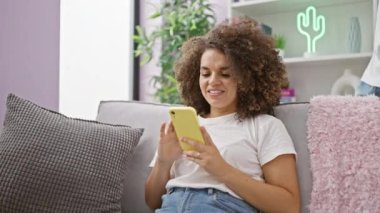 Güzel bir çift evdeki kanepede otururken gülmekten zevk alır, akıllı telefonlarına neşeli mesajlar atarlar..