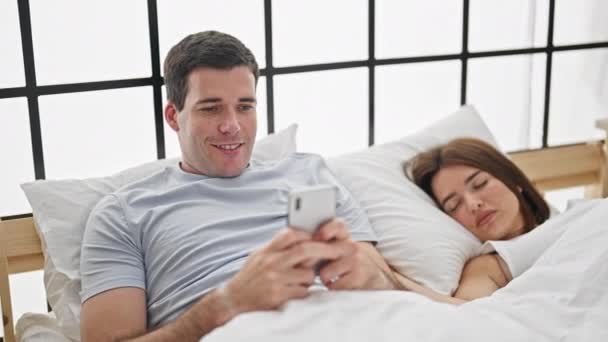 Beautiful Couple Lying Bed Using Smartphone While Girlfriend Sleep Bedroom — Stock Video
